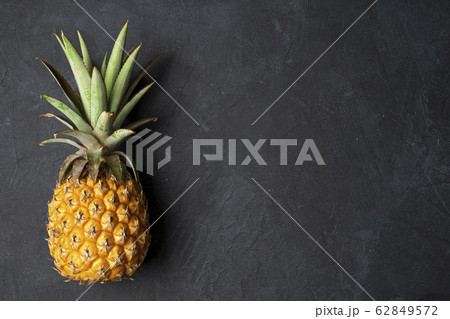 Fresh pineapple on black background, top view, 62849572