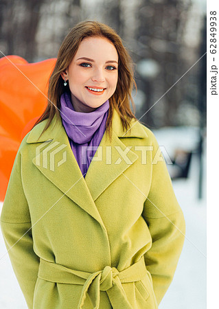 portrait of beautiful caucasian woman smiling at camera outdoors 62849938