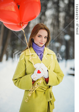 charming lady in coat with air balloons charming lady in coat with air balloons 62849941