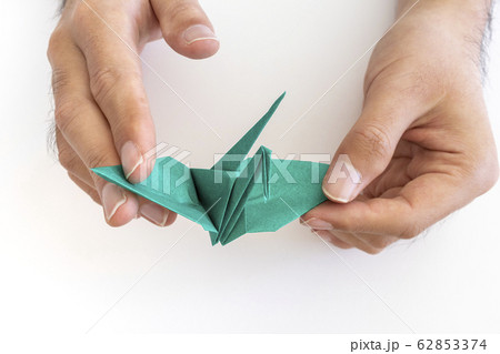 折り紙で鶴を折る男の手元 62853374