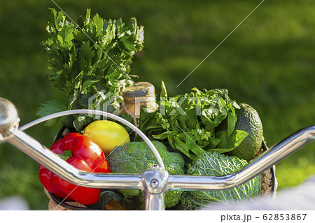Eco life. Bicycle full of fresh vegetarian products over green grass 62853867