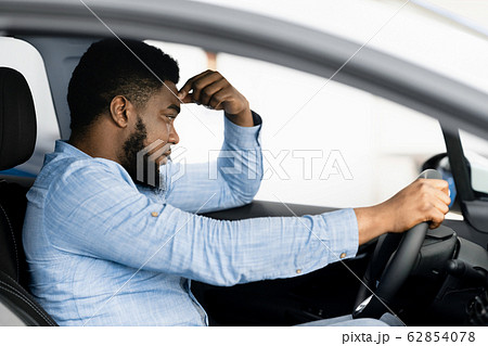 Depressed Man Sitting In Driver's Seat Of Too Expensive Car 62854078