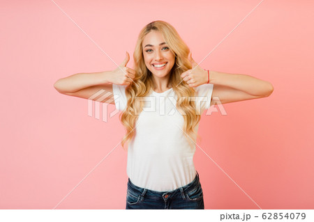 Like it. Pretty girl showing thumbs up with both hands 62854079