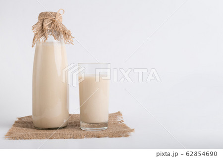 Soy milk in bottle and glass on linen cloth Soy milk in bottle and glass on linen cloth 62854690