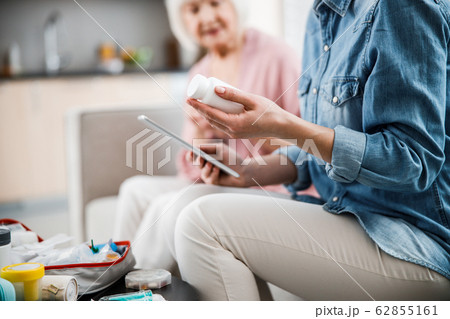 Young woman holding white bottle of vitamins Young woman holding white bottle of vitamins 62855161