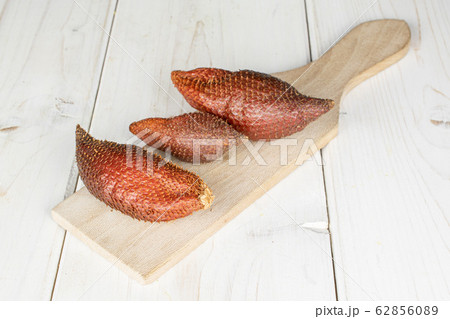 Exotic brown salak on grey wood Exotic brown salak on grey wood 62856089