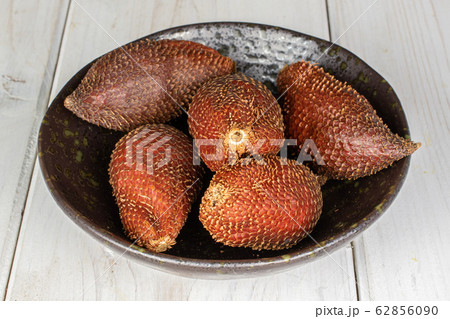 Exotic brown salak on grey wood Exotic brown salak on grey wood 62856090