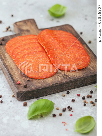 Spicy pepperoni salami with basil and pepper on 62856507