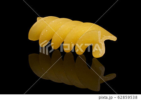 Yellow fusilli pasta isolated on black glass Yellow fusilli pasta isolated on black glass 62859538