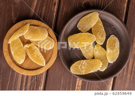 Dried yellow pineapple on brown wood 62859649