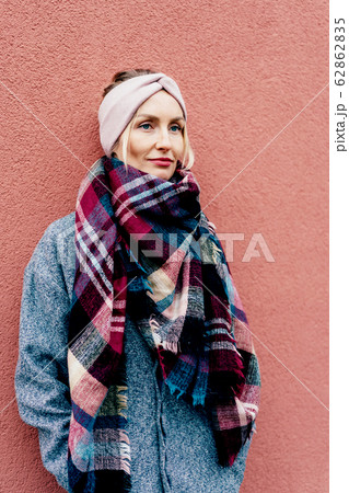 Chic stylish blonde in a coat and a large riveted 62862835