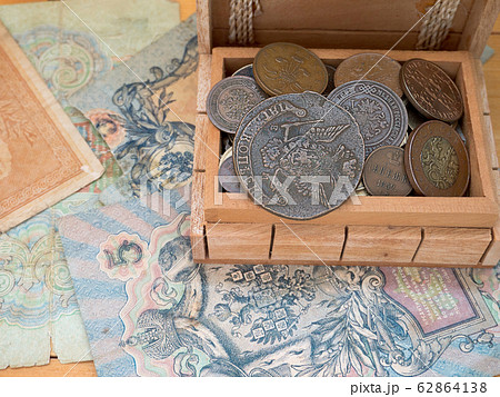 The hoard of old coins in a wooden box 62864138