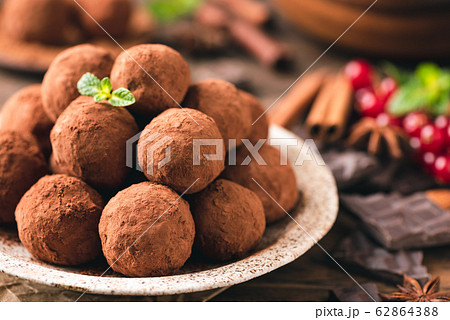 Pile of chocolate truffles rolled in cocoa powder Pile of chocolate truffles rolled in cocoa powder 62864388