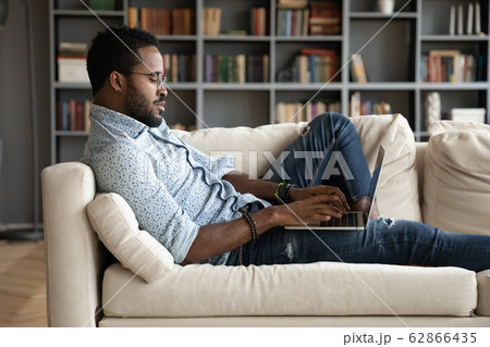 Concentrated mixed race young businessman communicating with partners clients. Concentrated mixed race young businessman communicating with partners clients. 62866435