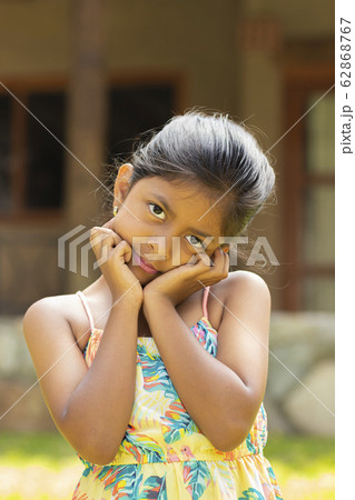 Portrait of little brunette girl with her hands on her face Portrait of little brunette girl with her hands on her face 62868767