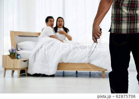 Husband holding knife while wife and adulterer are panic in bed room Husband holding knife while wife and adulterer are panic in bed room 62875706