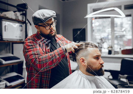 Stylish man sitting in a barbershop Stylish man sitting in a barbershop 62878459