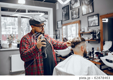 Stylish man sitting in a barbershop Stylish man sitting in a barbershop 62878463