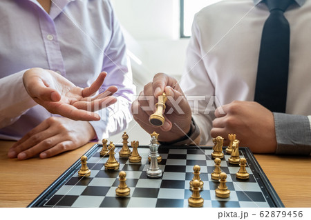 hand of businessman moving chess in competition, shows leadership, followers and business success strategies 62879456