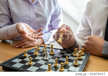 hand of businessman moving chess in competition, shows leadership, followers and business success strategies 62879457