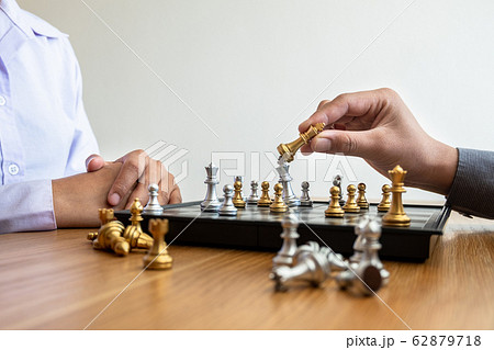 hand of businessman moving chess in competition, shows leadership, followers and business success strategies hand of businessman moving chess in competition, shows leadership, followers and business success strategies 62879718