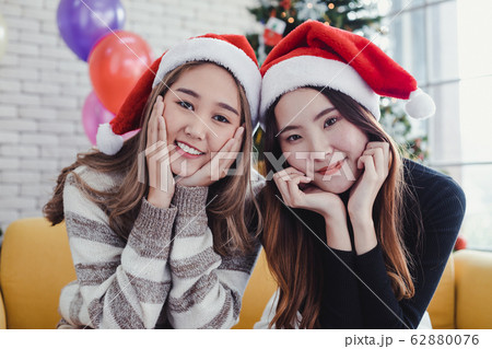 Portrait of two young Asian women dressing up for 62880076