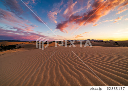 Sunset over the sand dunes in the desert Sunset over the sand dunes in the desert 62883137