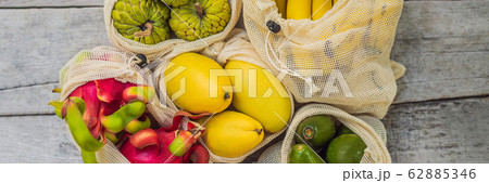 BANNER, LONG FORMAT Fruit in a reusable bag on a stylish wooden kitchen surface. Zero waste concept 62885346
