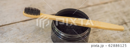 Activated charcoal powder for brushing and whitening teeth. Bamboo eco brush BANNER, LONG FORMAT 62886125