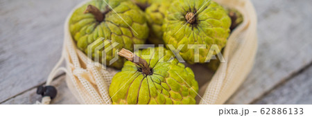 Cherimoya in a reusable bag on a stylish wooden kitchen surface. Zero waste concept, plastic free 62886133