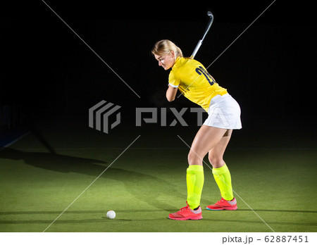 Field hockey girl player performing penalty stroke 62887451