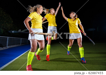 Three field hockey players celebrate the victory Three field hockey players celebrate the victory 62887455