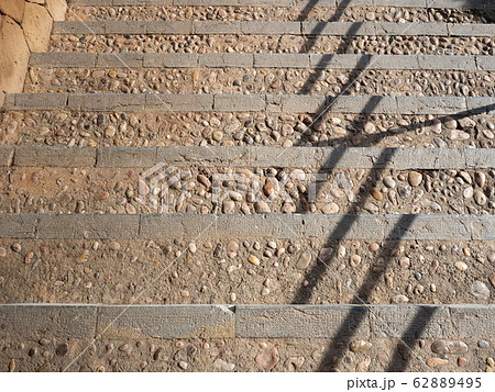 Stairs signate by time. Shadows from handrail. Stairs signate by time. Shadows from handrail. 62889495