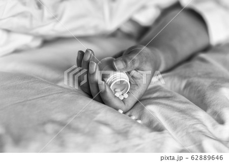 Suicide committing by drug overdose, Depressed woman suffer from insomnia problem. 62889646