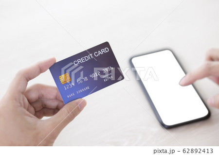 Hand holding credit card and touch smartphone 62892413