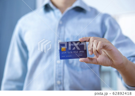 Man hand holding front credit card wear shirt 62892418