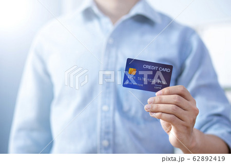 Man hand holding front credit card wear shirt 62892419