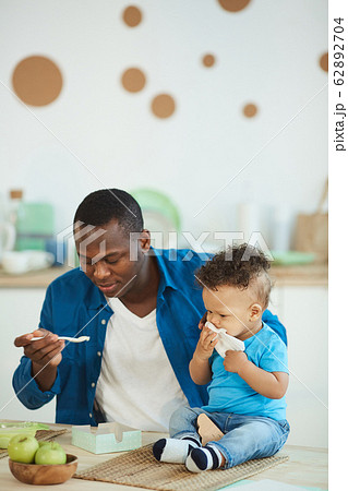 Caring Father Feeding Baby Son 62892704