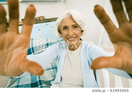 Cheerful Mature Lady Making Self Photos On Kitchen Back Cheerful Mature Lady Making Self Photos On Kitchen Back 62893060