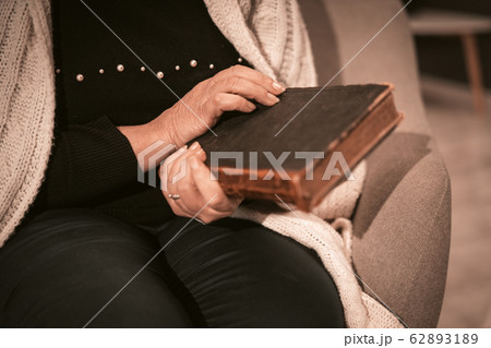 Senior Woman Holds Old Book In Her Hands Close Up. Senior Woman Holds Old Book In Her Hands Close Up. 62893189