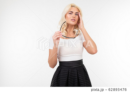 Girl is having a headache and stress while wearing glasses for vision. white background and empty Girl is having a headache and stress while wearing glasses for vision. white background and empty 62893476