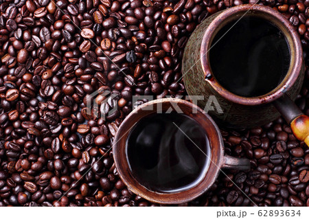 Turk and steaming hot coffee in clay cup on coffee Turk and steaming hot coffee in clay cup on coffee 62893634