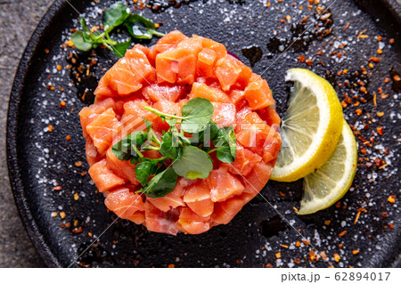 Raw salmon, avocado purple onion salad served in 62894017