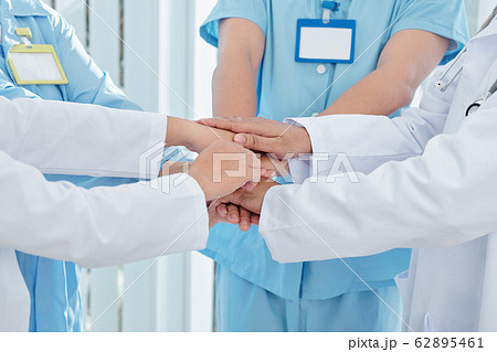 Medical worker stacking hands 62895461