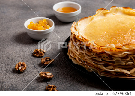 Homemade pancakes with honey oh the grey table. Macro. Homemade pancakes with honey oh the grey table. Macro. 62896864