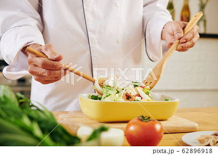 Cook mixing salad Cook mixing salad 62896918