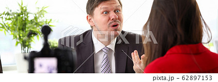 Young businessman feeling mad and expressing anger to woman colleague 62897153