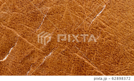 Brown leather material with cracks as background Brown leather material with cracks as background 62898372