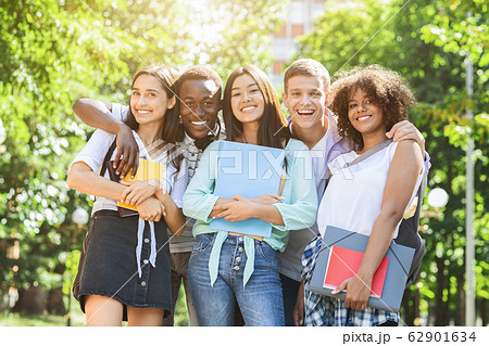 Portrait of happy multicultural students posing at camera outdoors 62901634