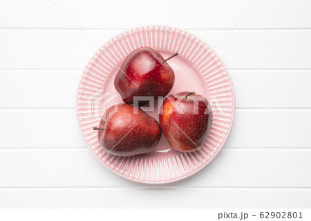 Three ripe red apples. 62902801
